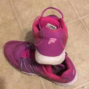 A pair of worn Fila shoes size 6 US.